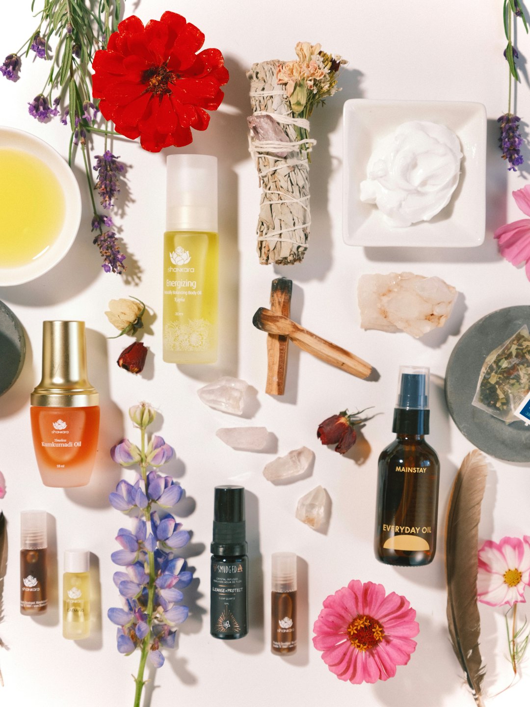 Natural wellness products and botanicals arranged on a white surface.